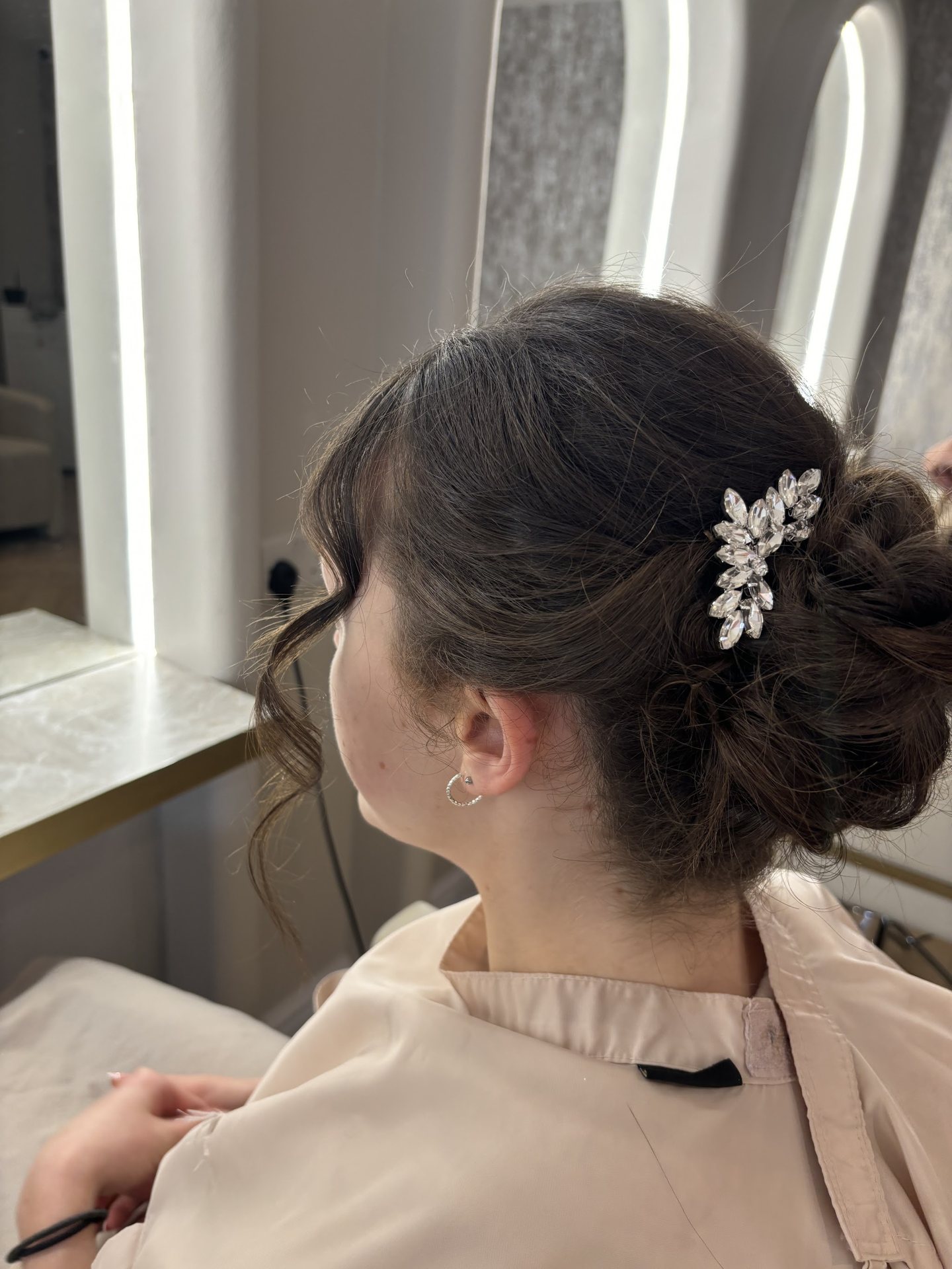 Finished bridal updo with a delicate hair accessory